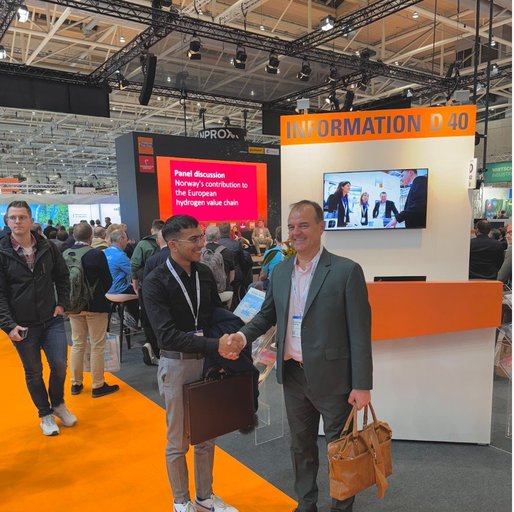 Alphasol team member shaking hands with a partner at an international trade show